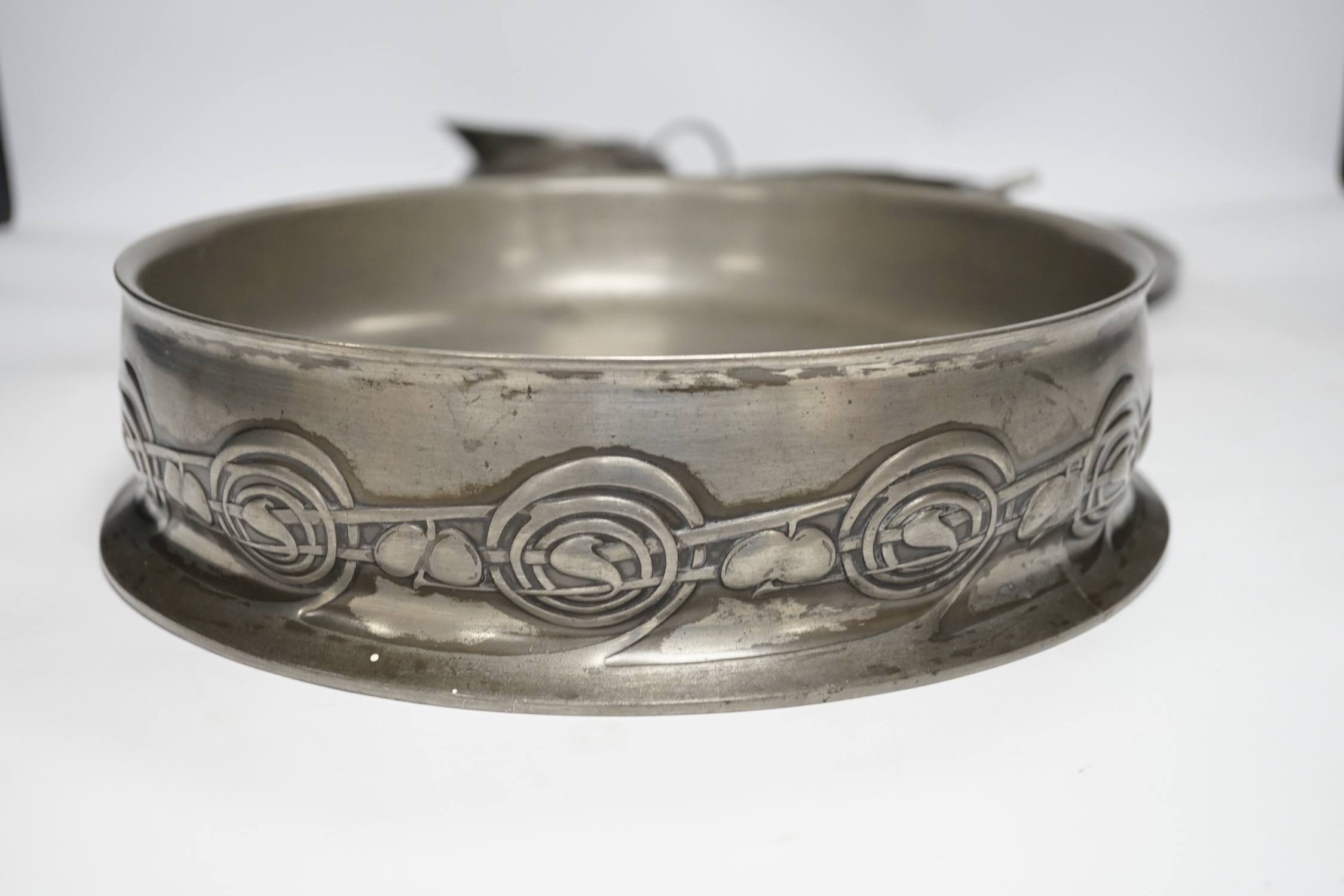 Seven items of pewter, including a Liberty Tudric tray, 45.5cm width, an Archibald Knox jug, a large Tudric bowl, 27cm diameter, a dish with glass liner, another dish and two paper knifes